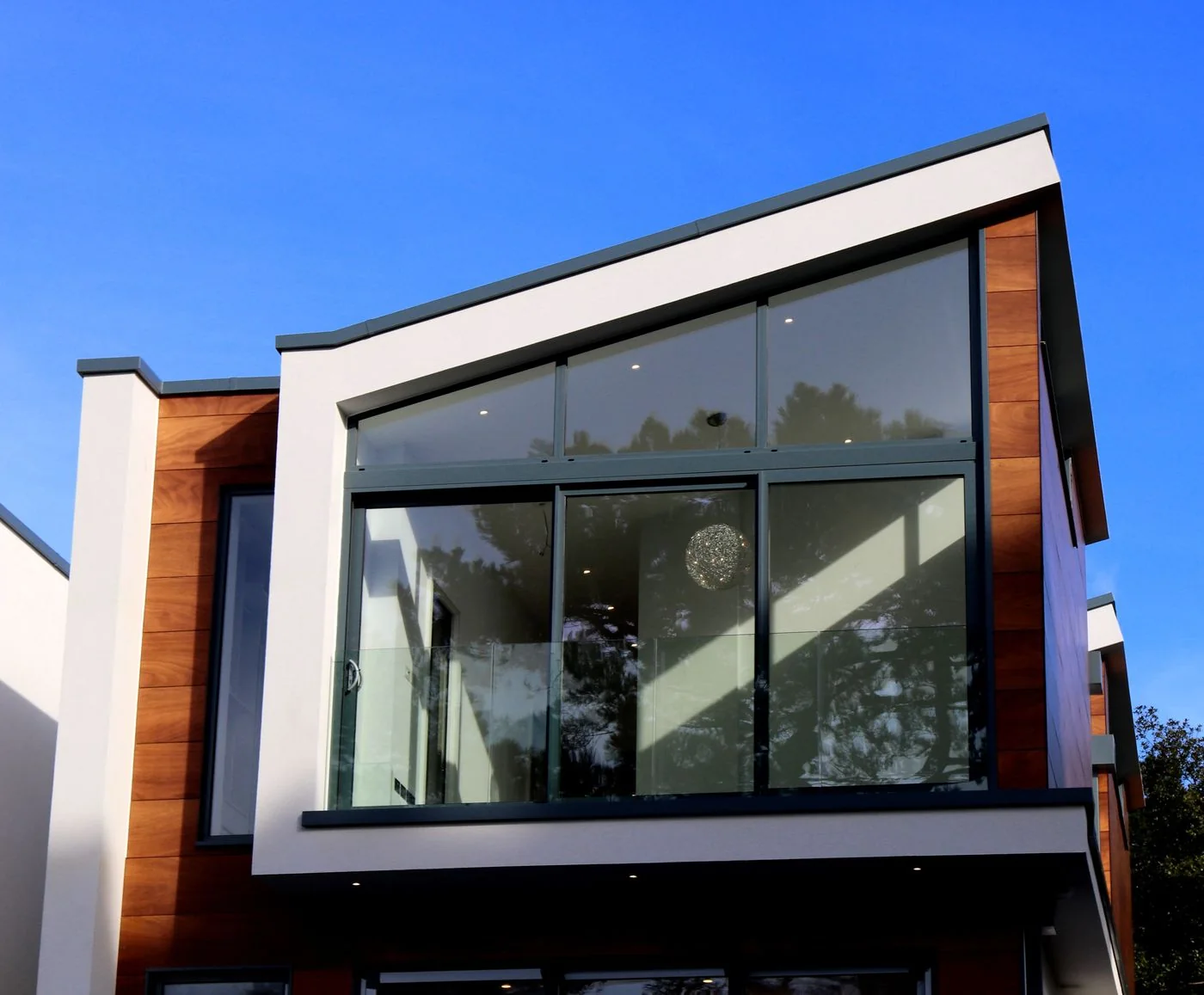 Contemporary house with glass windows and timber cladding